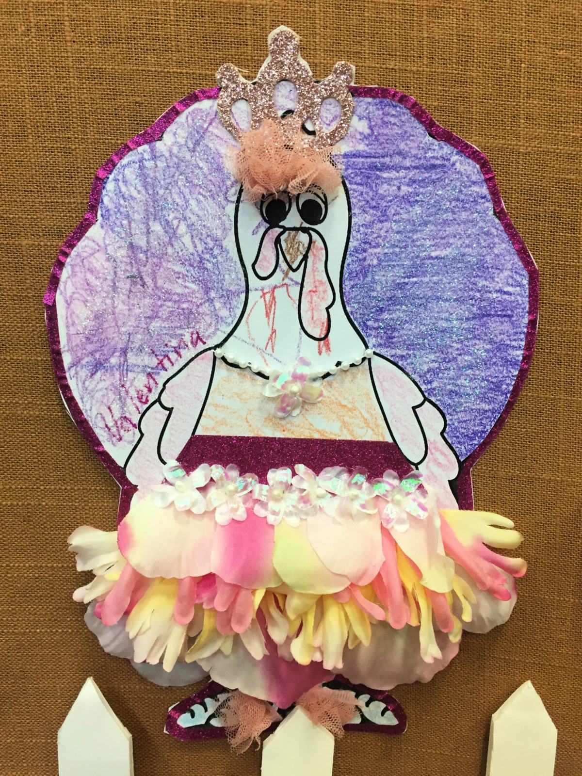 Paper Turkey In Disguise dressed as a Princess with flower petal tutu, purple top and glitter.