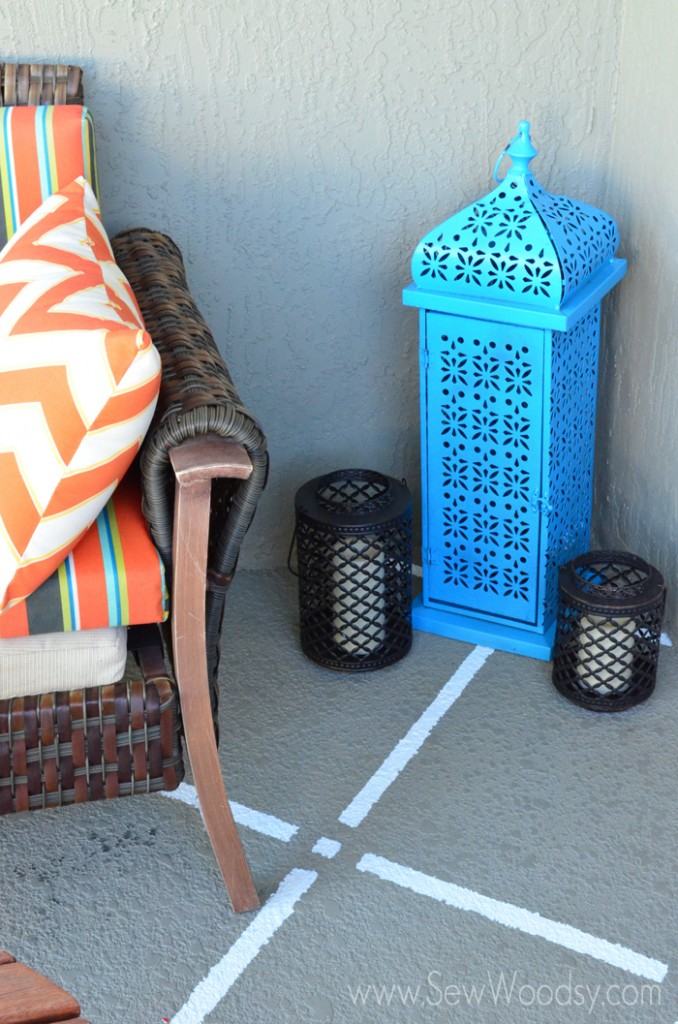Tan floor with white squares, blue lantern and couch.