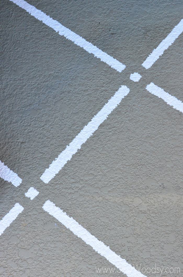Close up of stripped paint -- painted on a concrete pad.