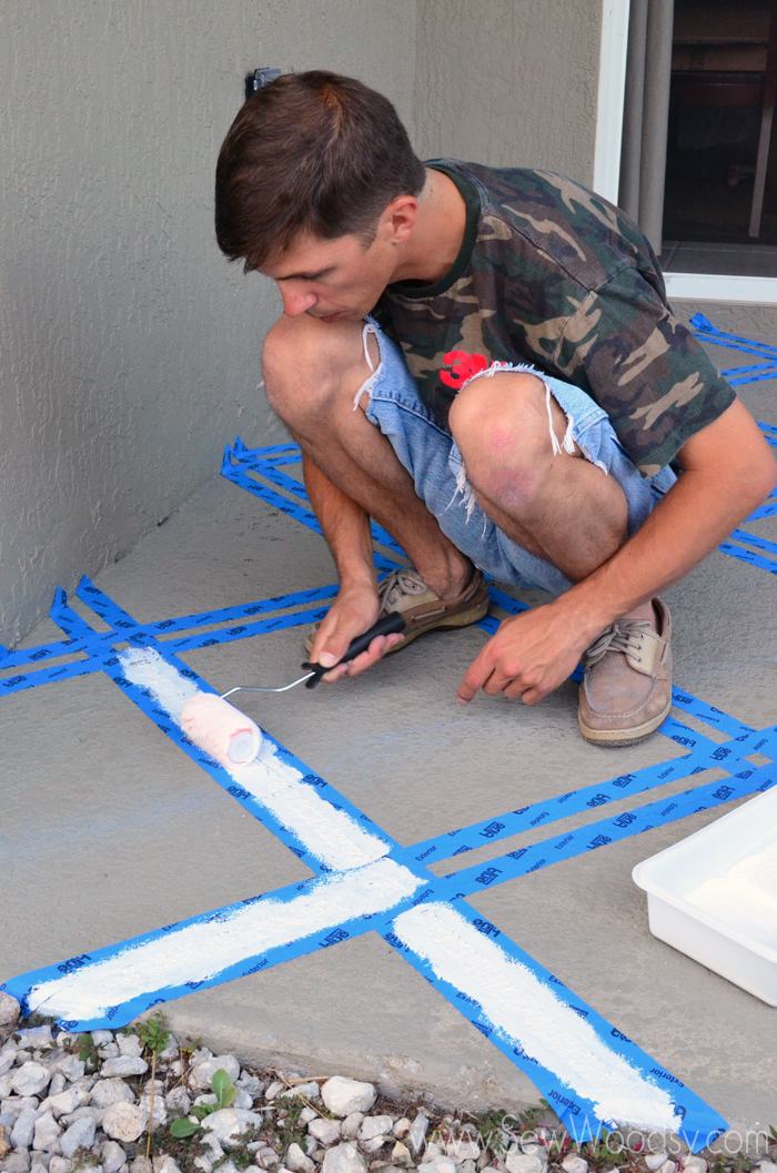 Man rolling paint onto painters tape.
