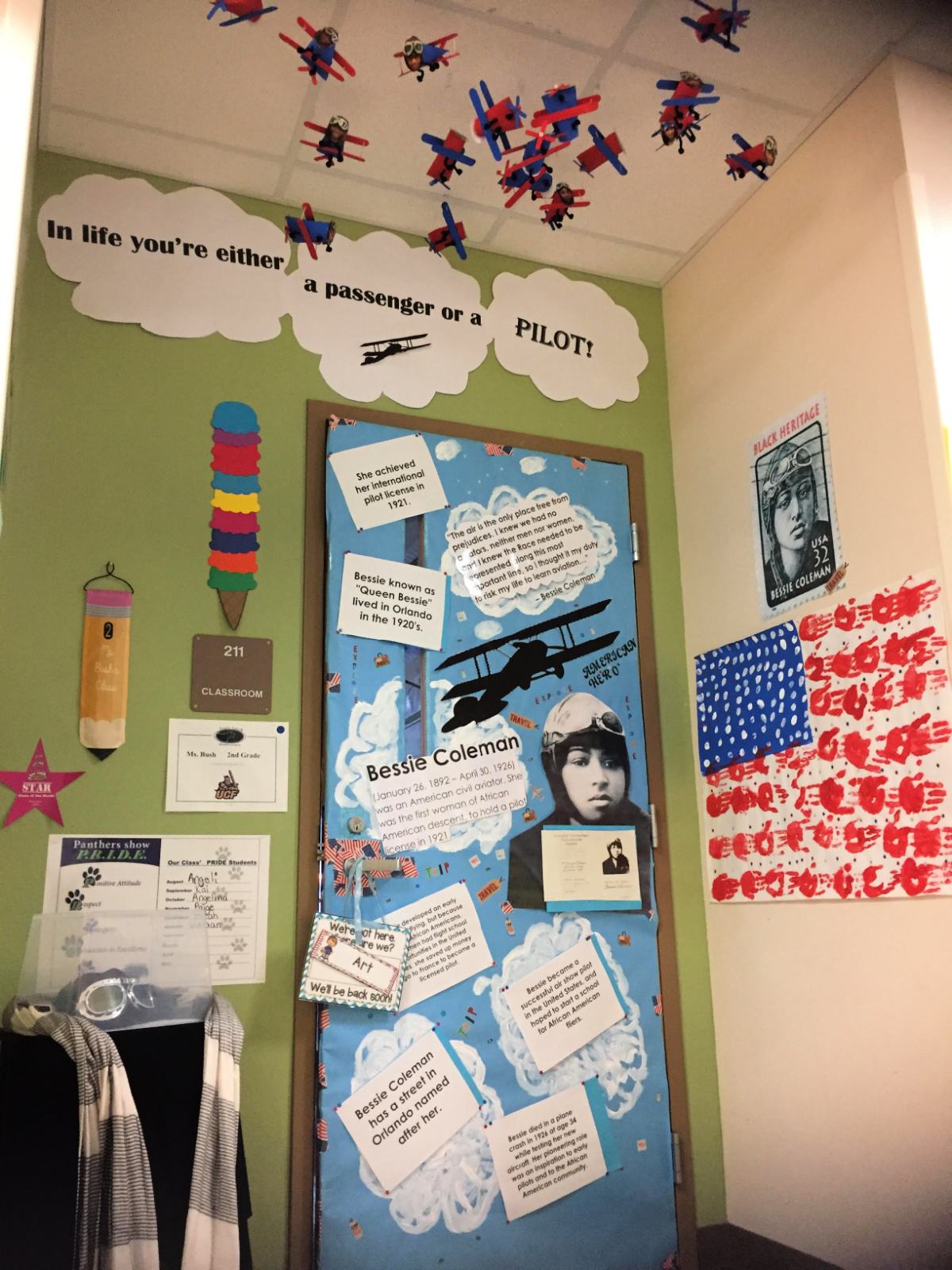 Bessie Coleman on the door with blue paper and clouds.