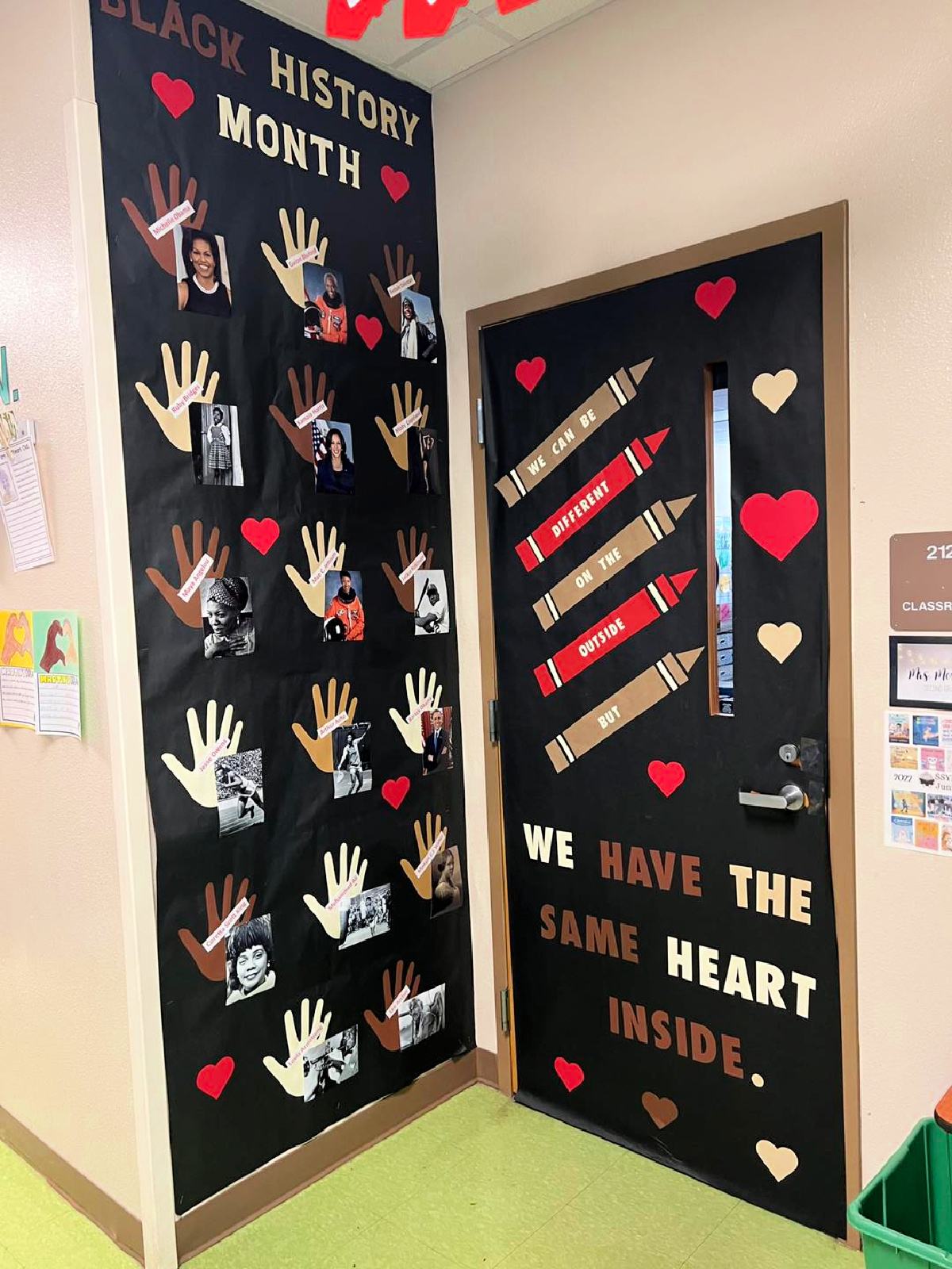 Black door and wall with words on door, crayons, and cream and red hearts.