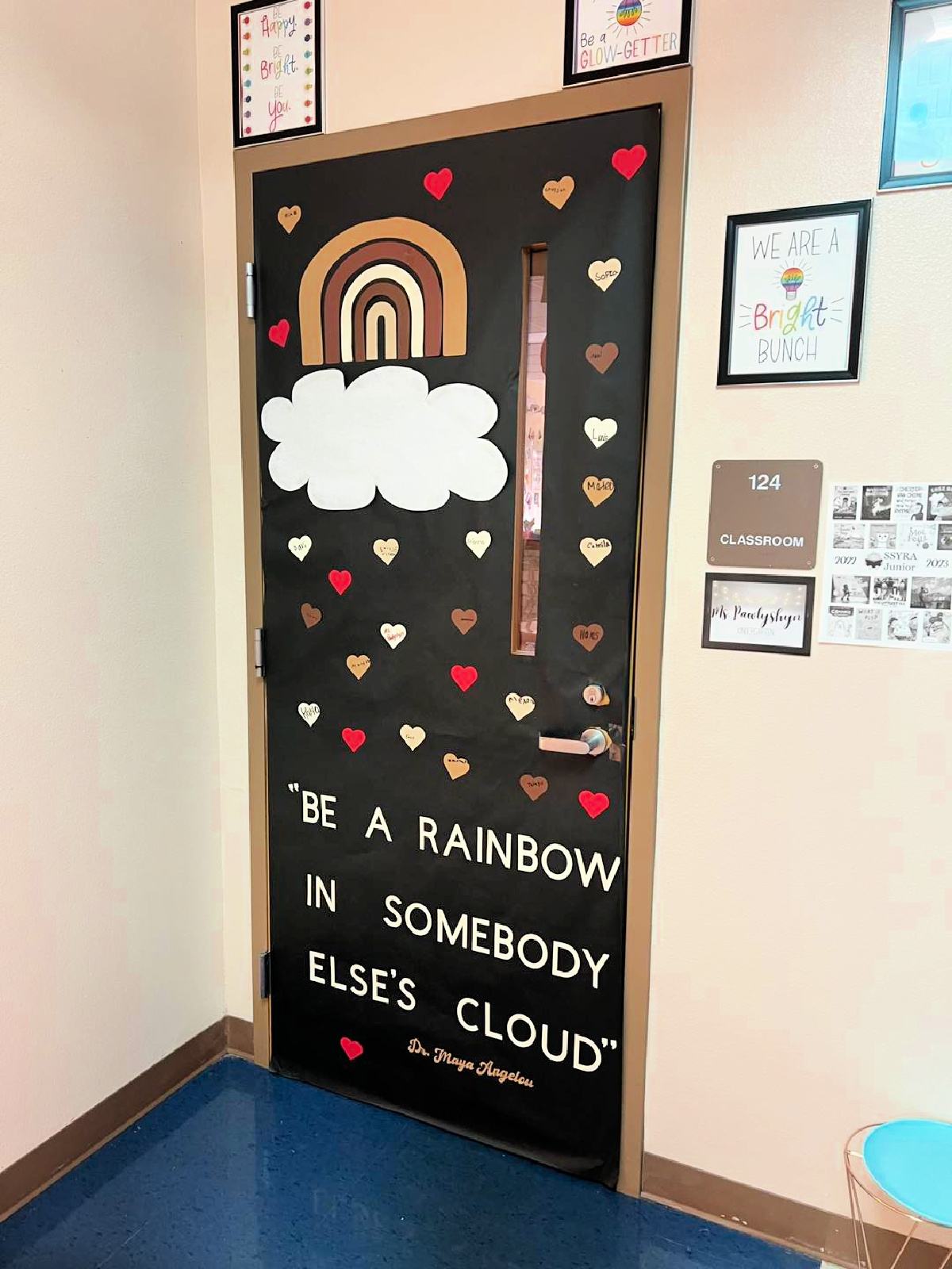 Black door with brown, cream, and red hearts with a Maya Angelou quote.