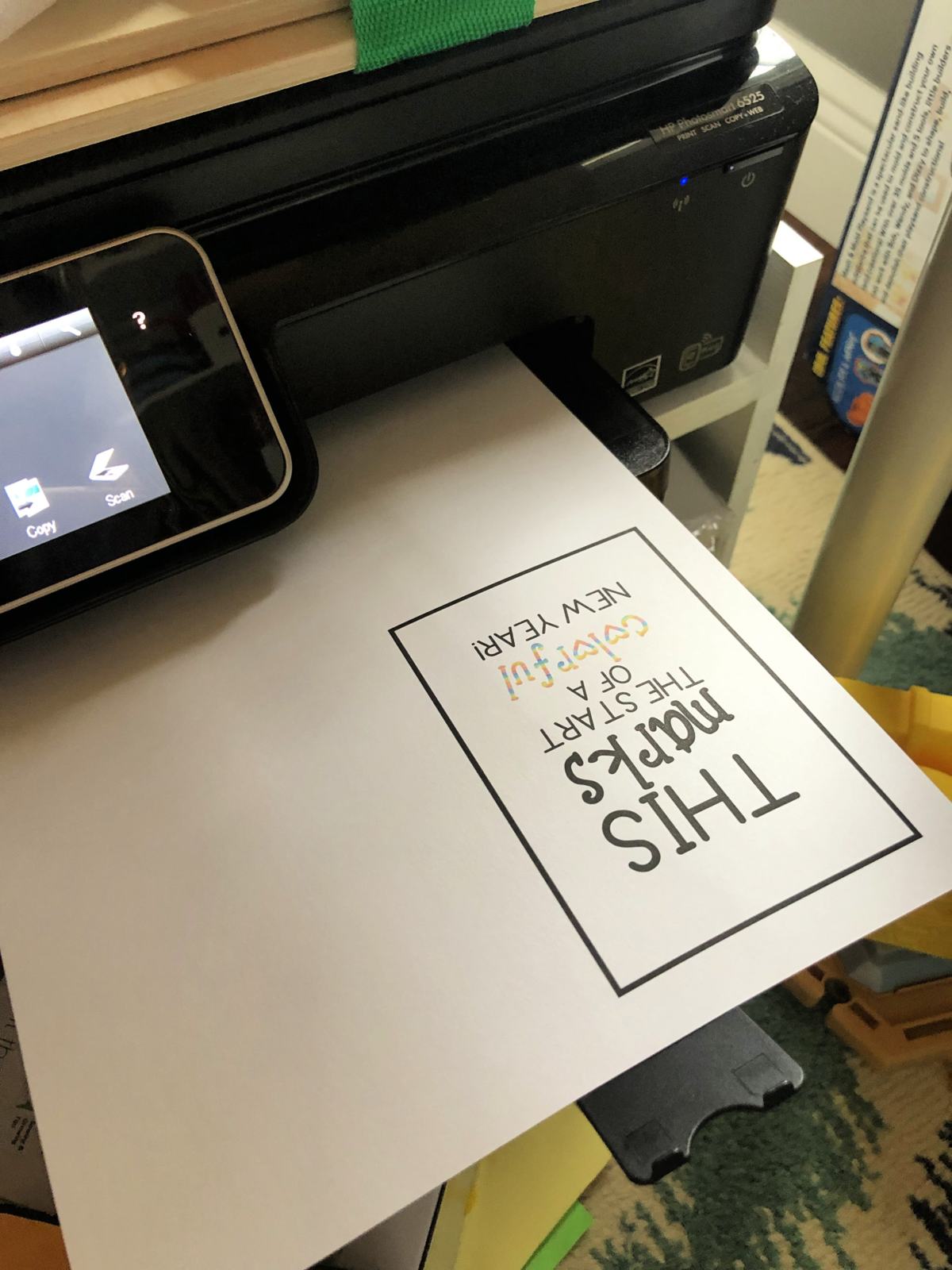 Black printer with a white paper printed with a rectangular box and print in it.