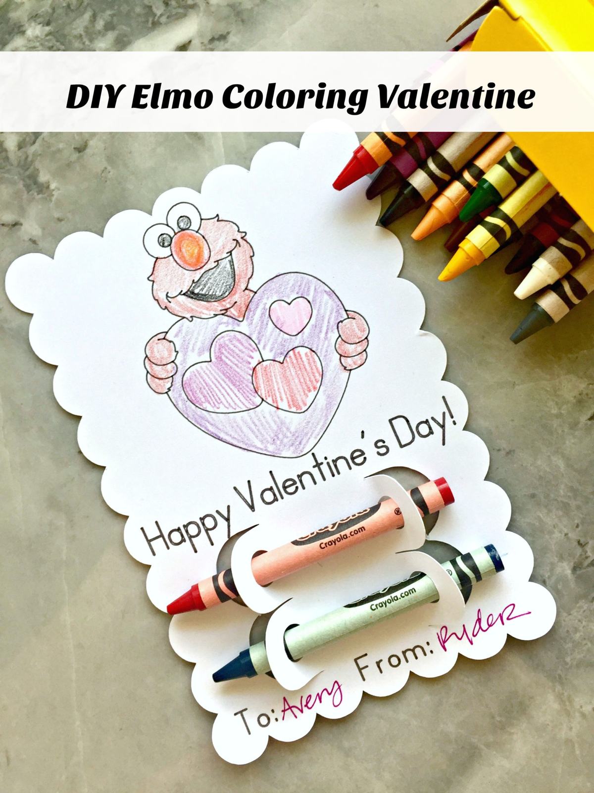 White scalloped edge paper with text and Elmo image on it with 2 crayons on it and crayon box next to it.