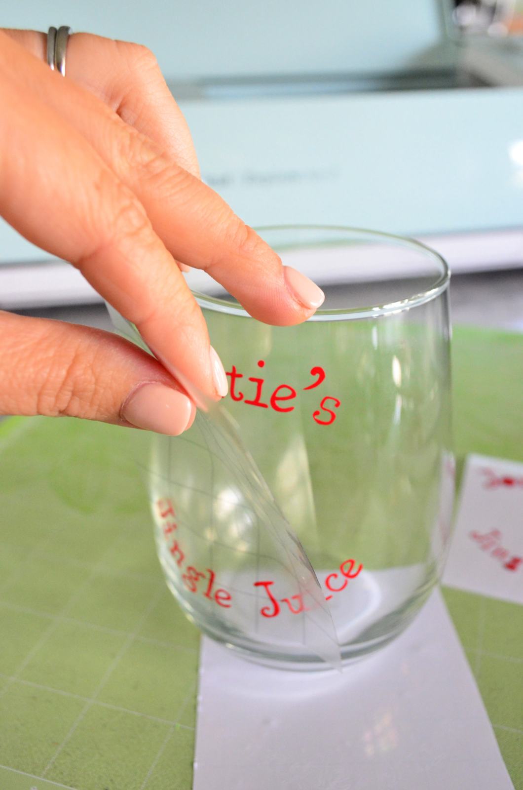 DIY Personalized Jingle Juice Wine Glasses applying vinyl to glass