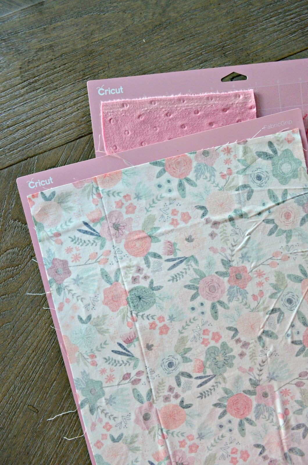 Two pink mats stacked with fabric on it.