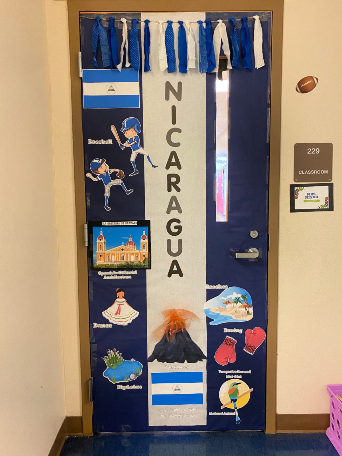 Nicaragua themed school door with baseball, boxing, falmenco dancers, and volacano.