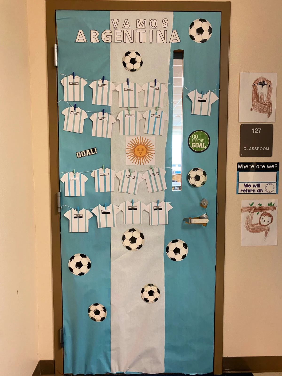 Blue and white door that says Vamos Argentina with soccer balls and soccer jerseys.