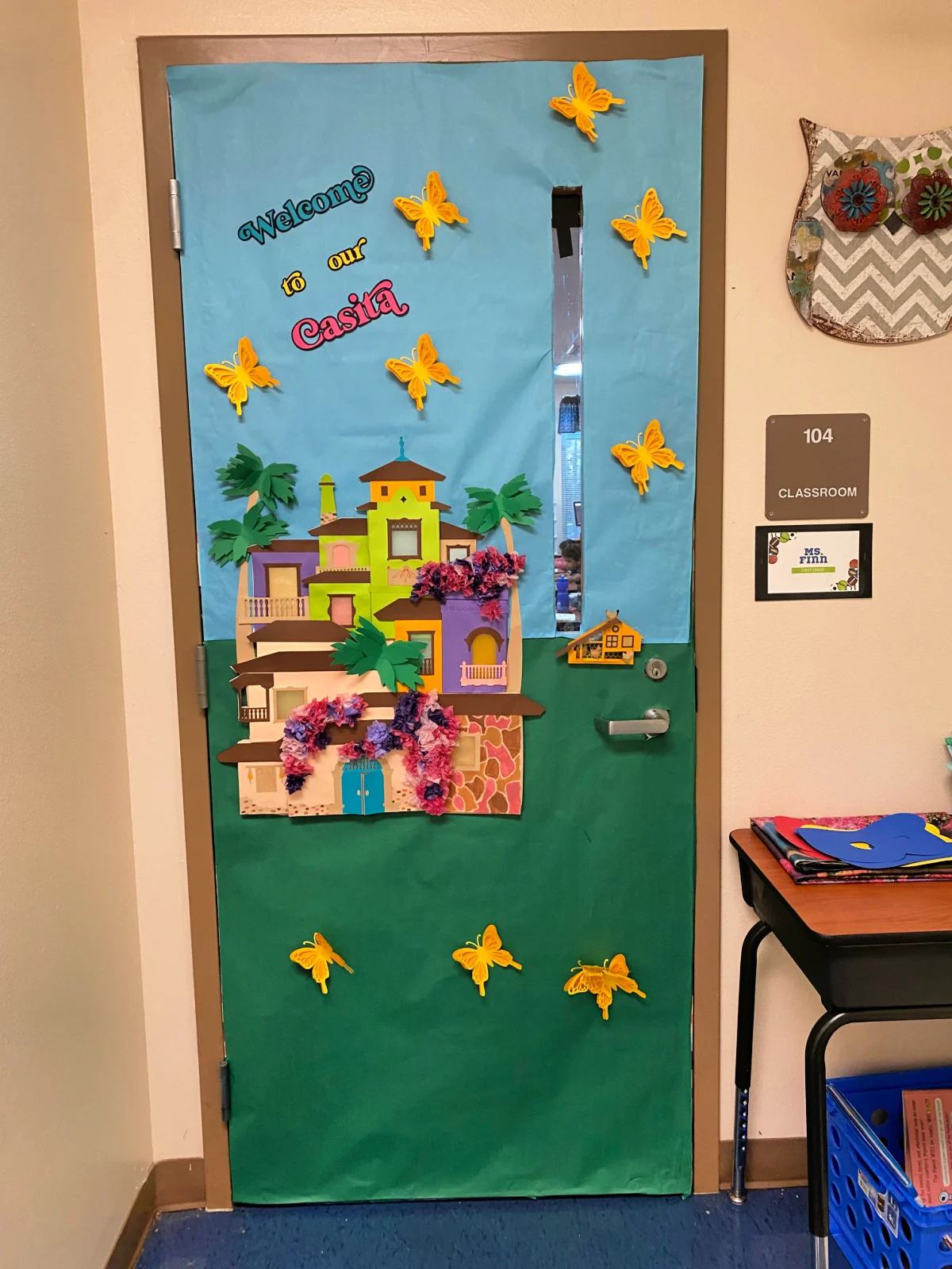 Blue and green classroom door that says "welcome to our casita".