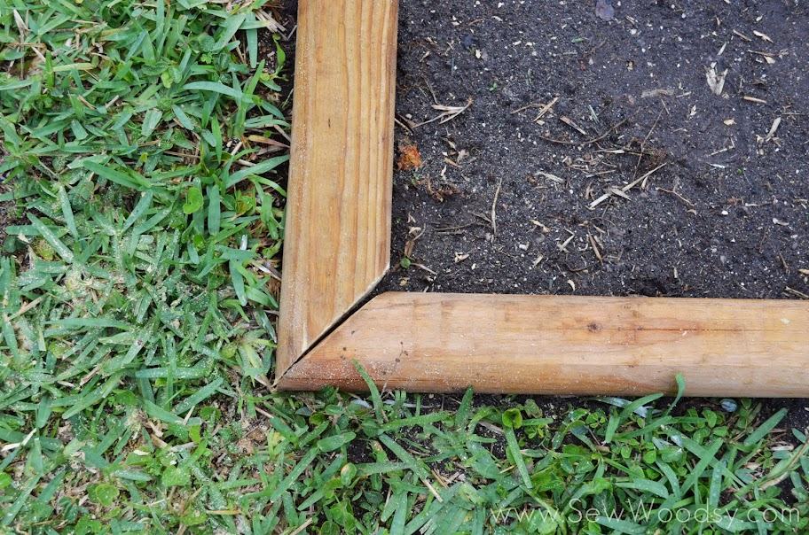 Two pieces of wood cut at the edge to make a frame.