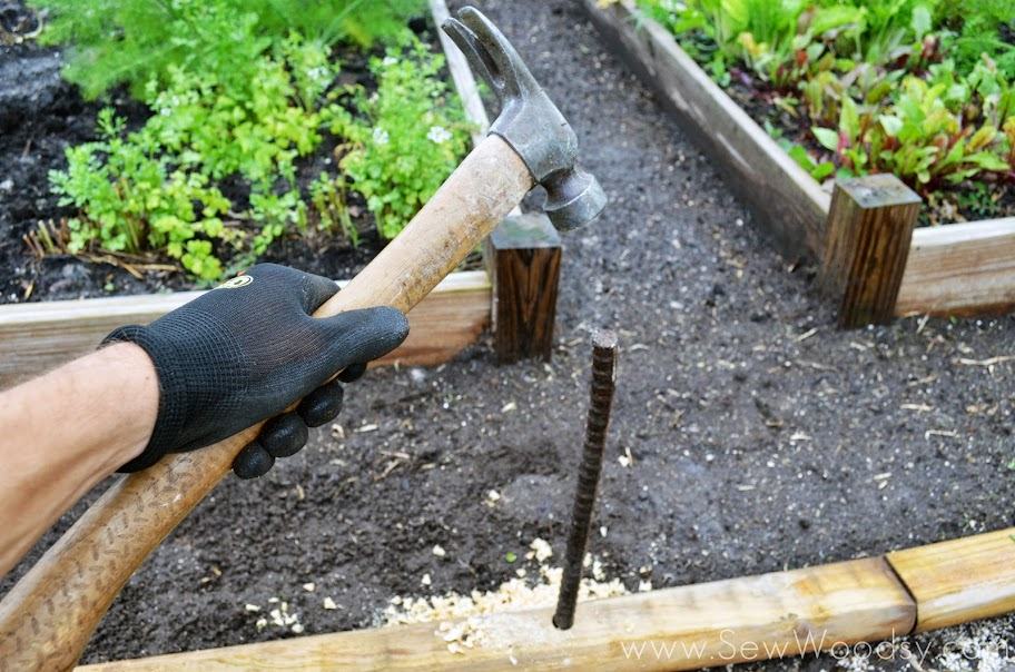 Rebar sticking out of wood hammering the bar.