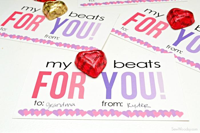Three valentine's with heart candies on top.