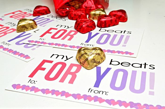 Four valentine's with heart candies on top.