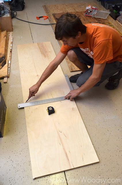 measuring PureBond Plywood with a square