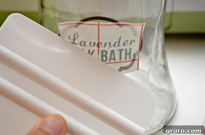 Craft a Custom Lavender Milk Bath 16 Smoothing custom vinyl label on jar with a plastic applicator for DIY Milk Bath