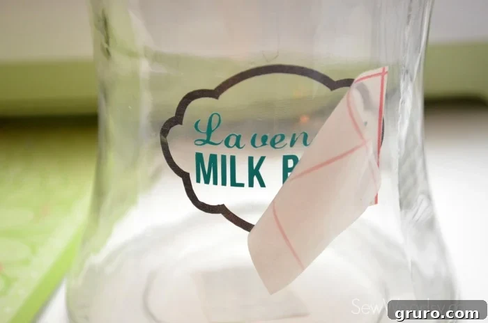 Craft a Custom Lavender Milk Bath 17 Carefully peeling transfer tape from DIY Lavender Milk Bath jar label