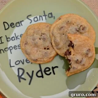 Green plate with text on plate and three cookies stacked on top.