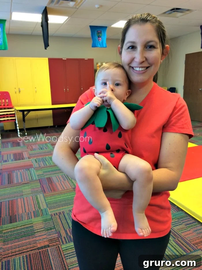Baby wearing a cute homemade strawberry Halloween outfit