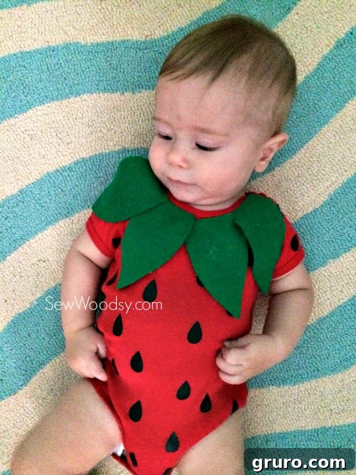 Happy baby in a DIY strawberry costume