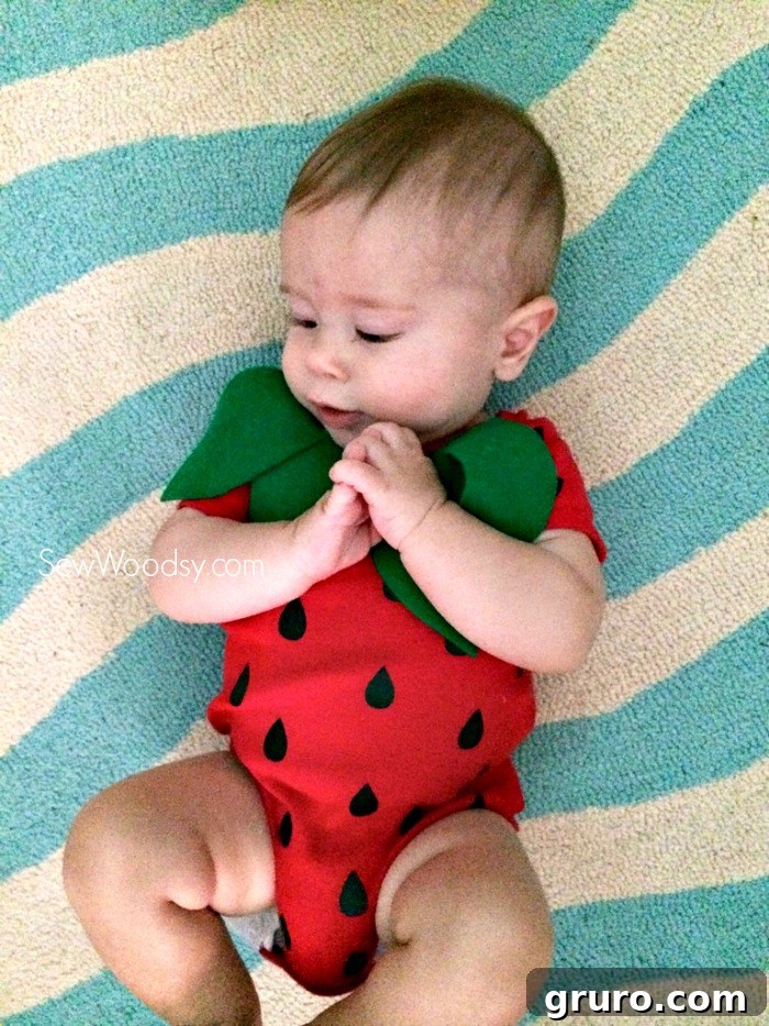Adorable infant modeling a simple homemade strawberry costume