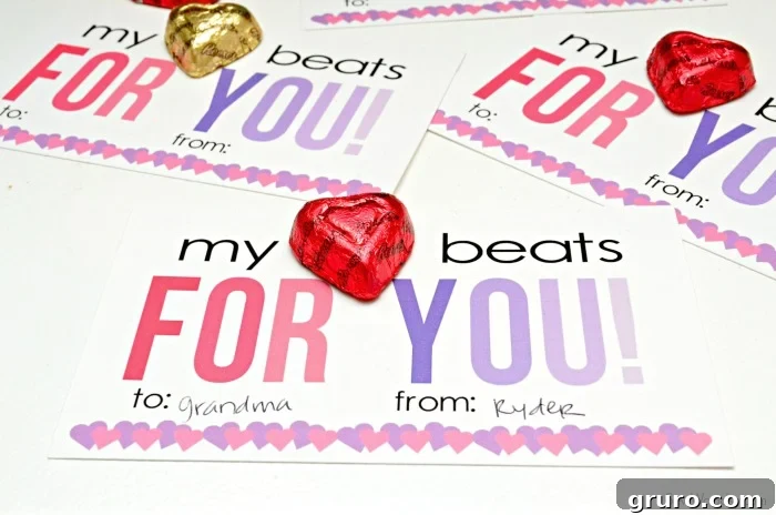 Pitter-Patter Valentine: Classroom Edition 12 Three Valentine cards with Reese's Heart candies on top, artfully composed for a charming presentation.