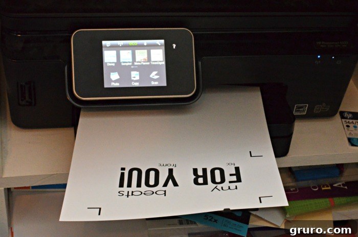 Pitter-Patter Valentine: Classroom Edition 5 A black printer with a piece of paper displaying a "My Heart Beats For You" Valentine design after printing.