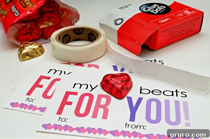 Pitter-Patter Valentine: Classroom Edition 8 A stack of finished Valentine cards, with a Reese's Heart candy taped onto the top card using a glue dot.