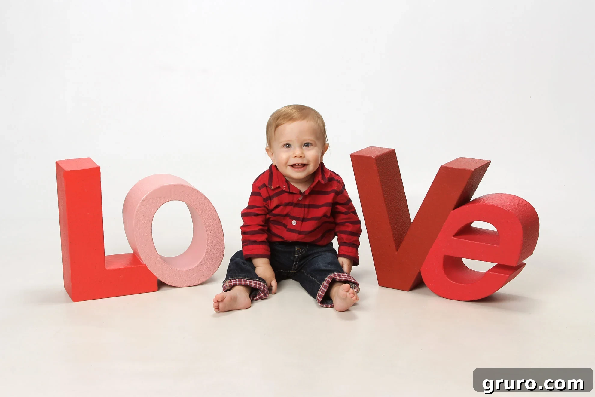Romance in Focus 3 The letters "l o v e" with a baby sitting happily in the middle.