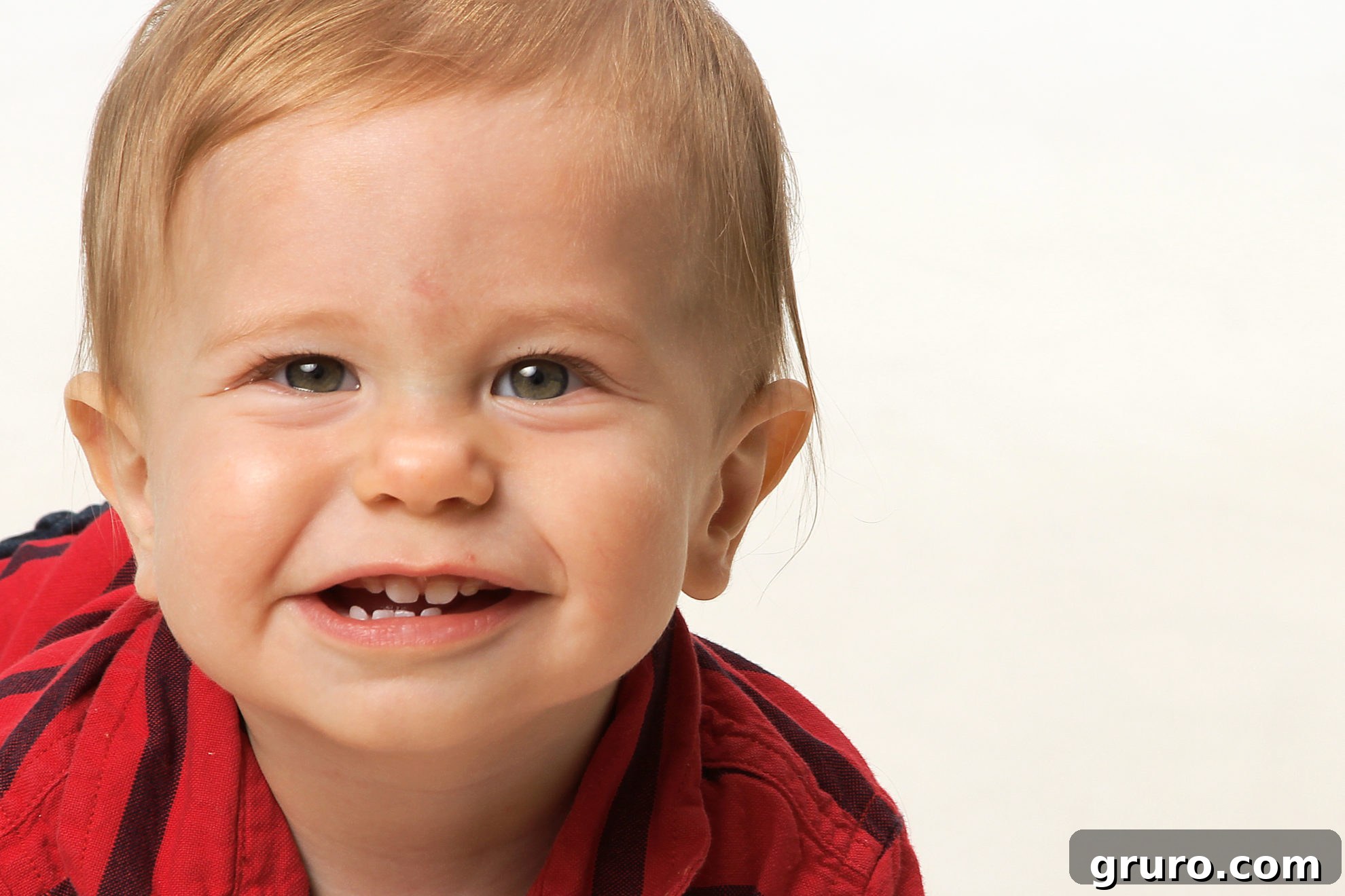 Romance in Focus 5 Blonde hair male baby with a squishy, cute face looking at the camera.