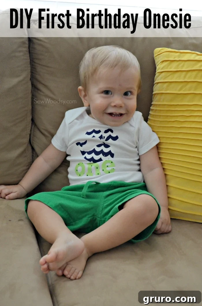 Adorable baby boy wearing custom 'ONE' first birthday onesie with a playful expression