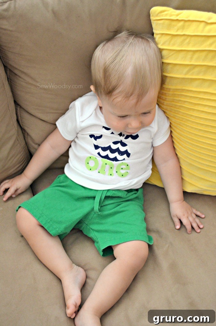 Happy baby boy Ryder smiling in his DIY 'ONE' first birthday onesie