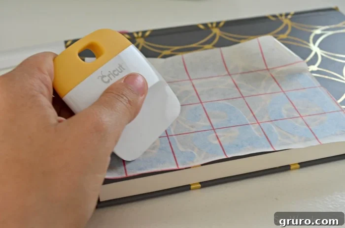 Applying vinyl transfer tape to the DIY Father's Day Journal design