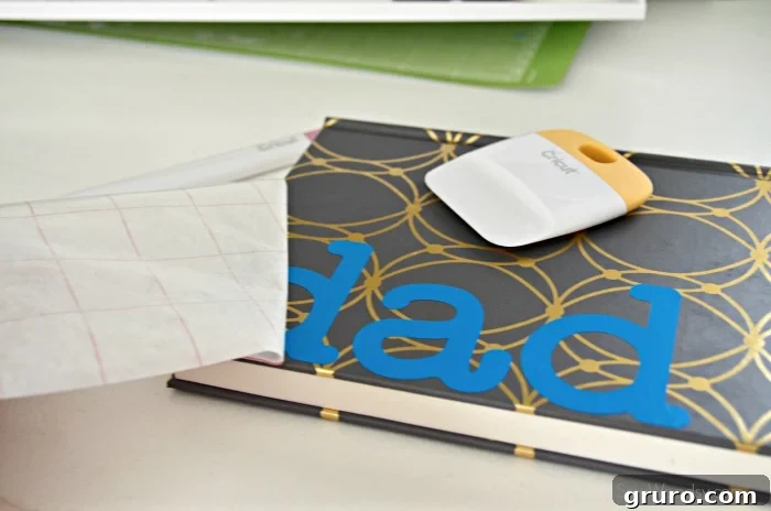 Placing the vinyl design on the DIY Father's Day Journal cover