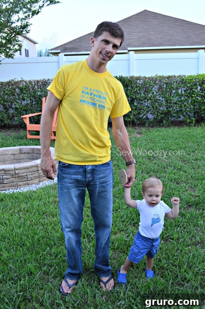 Jon laughing joyfully while wearing his custom 'Proud Father' t-shirt