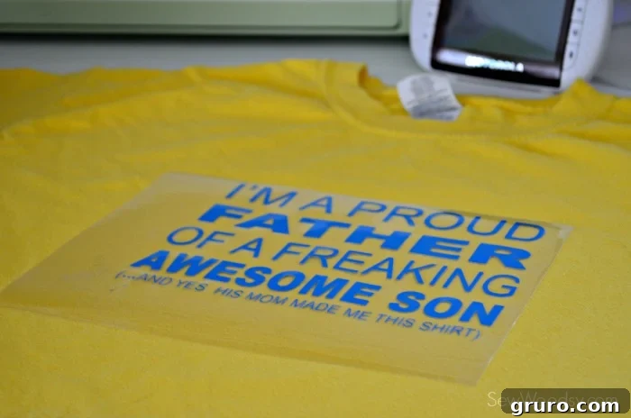 Weeded 'Proud Father' iron-on vinyl design ready for application