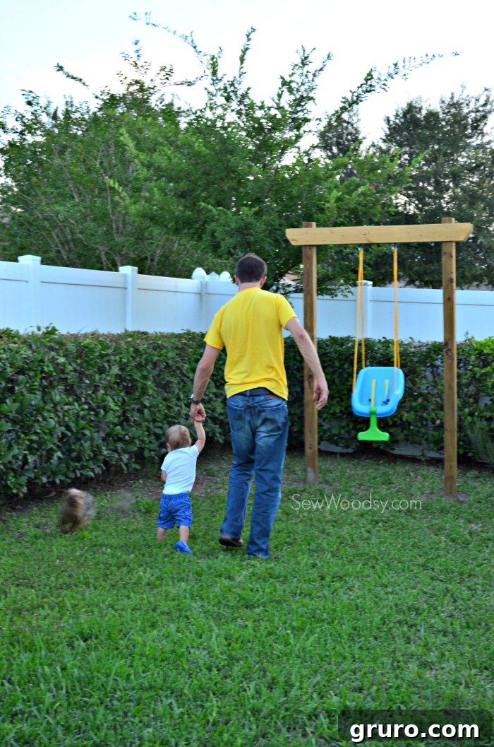 Ryder walking to the swing with his 'My Dad Rocks' Onesie
