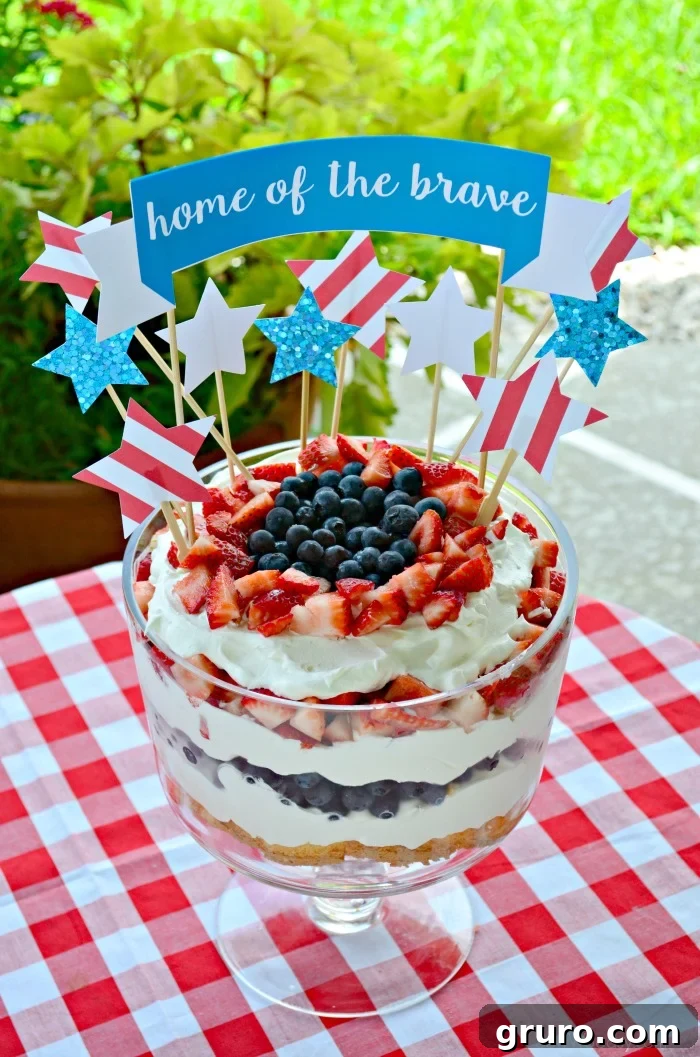 Home of the Brave cake topper on a red, white, and blue berry trifle cake