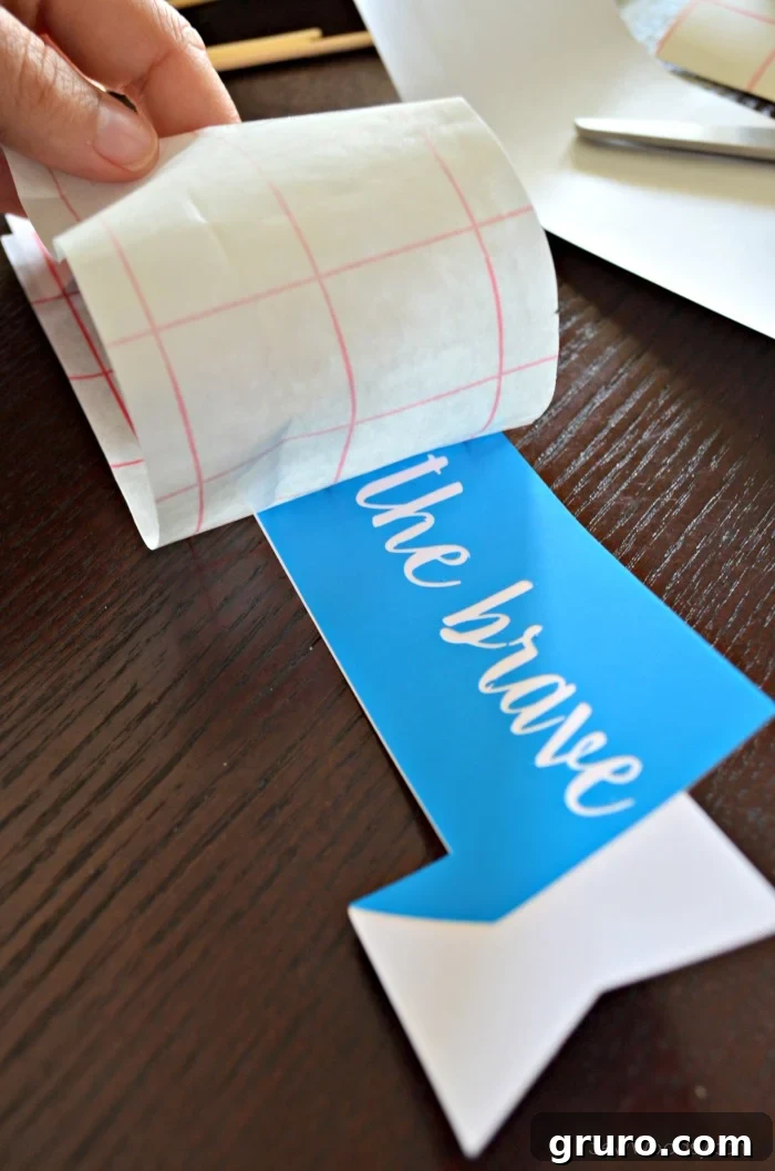 Smoothing vinyl onto cake topper banner