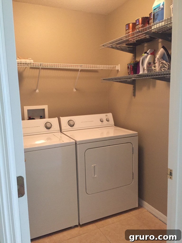 Compact laundry room with existing tile