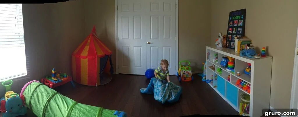 Spacious toddler playroom with a tent, toys, and colorful alphabet mat, fostering imaginative play