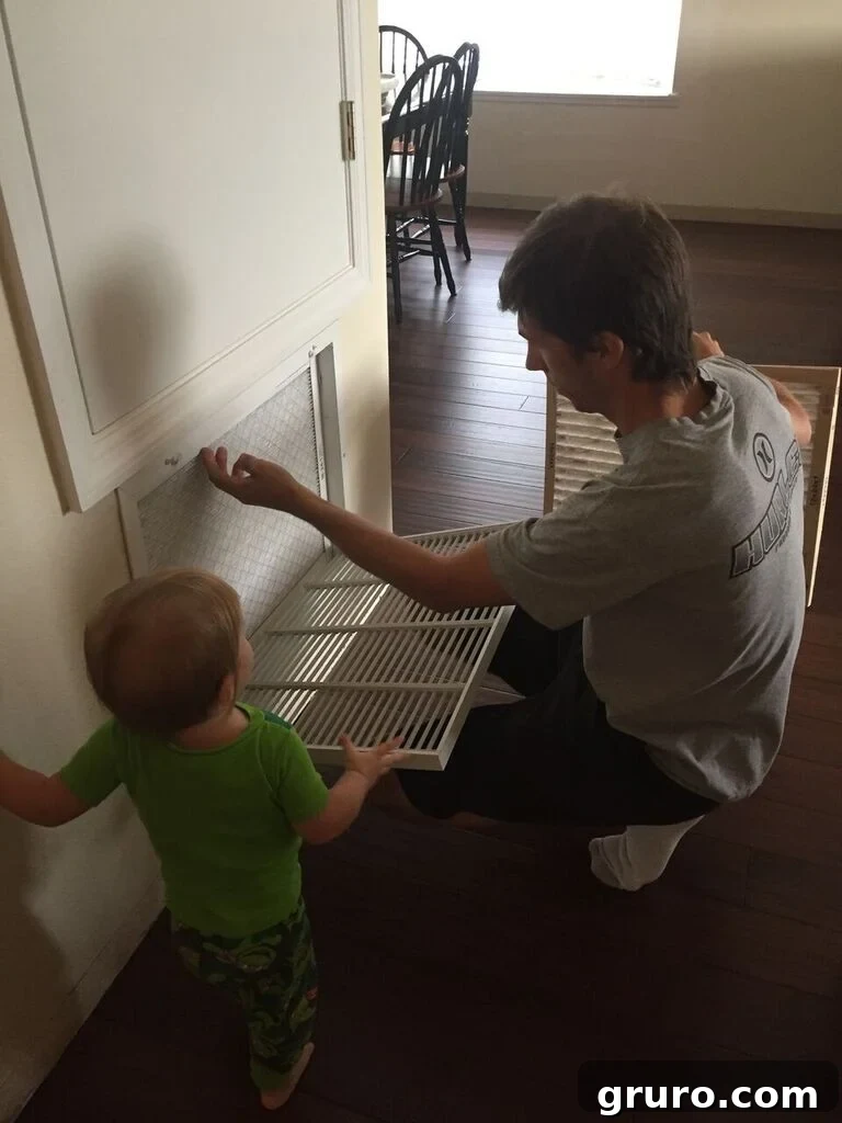 Changing a dirty air filter with a clean new one, demonstrating routine home maintenance