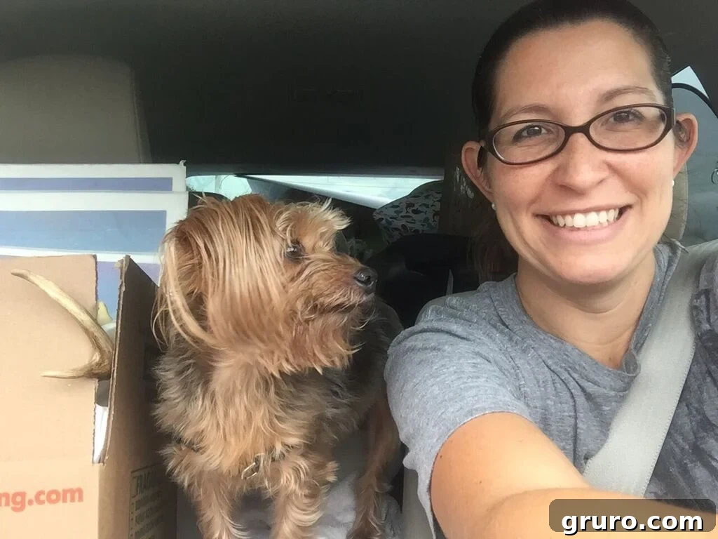 Woman with her Yorkie dog, Lola, amidst moving boxes, a relatable scene of pet owners during relocation