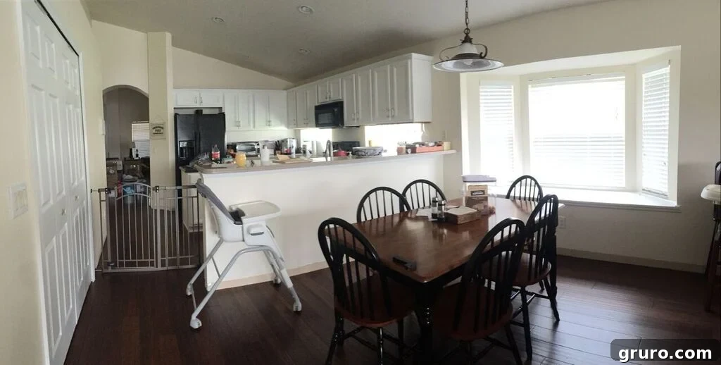 Open concept dining room and kitchen in a new home, with some boxes, showing potential and progress