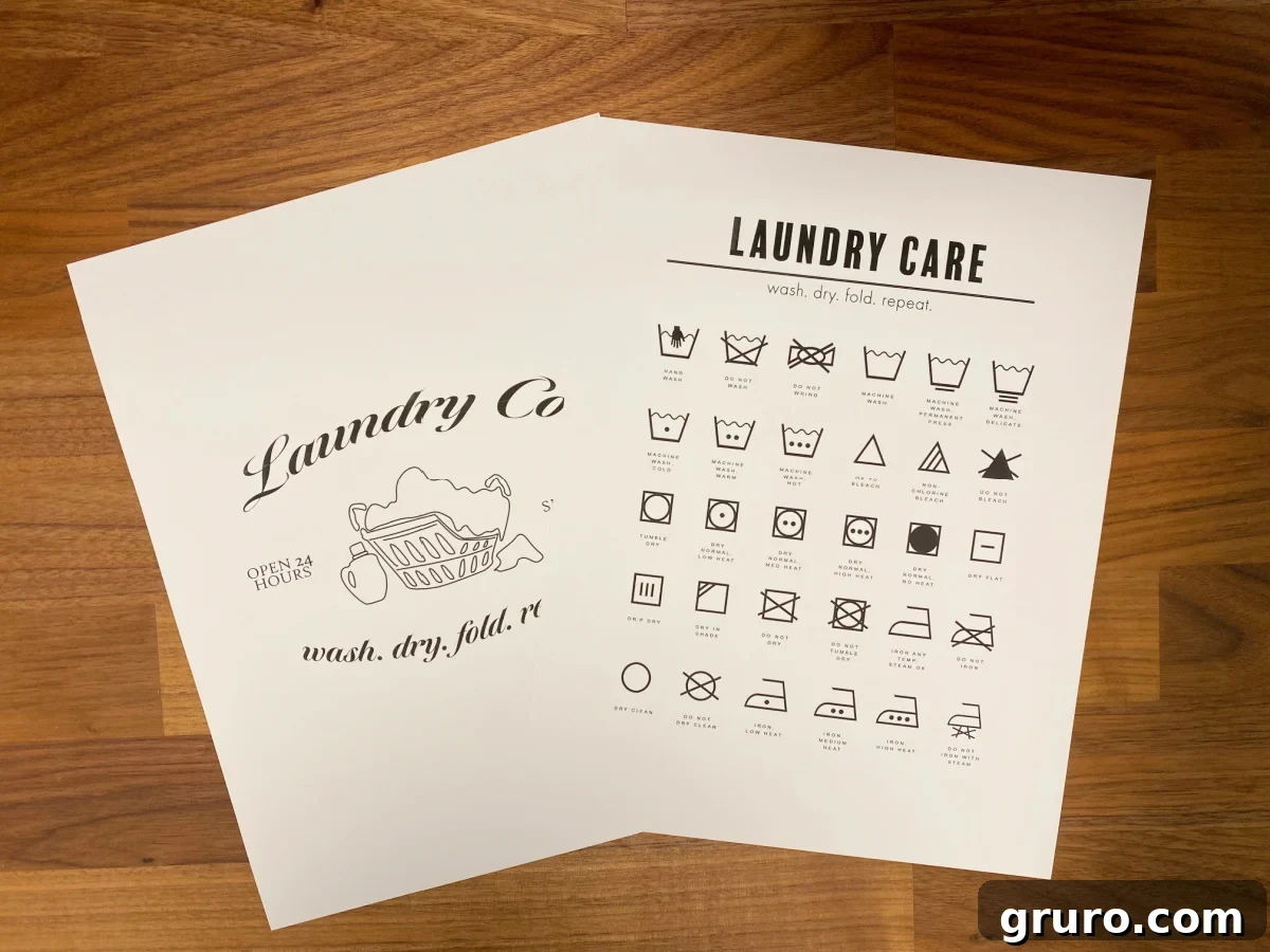 Your Printable Laundry Cheat Sheet 7 Two aesthetically pleasing laundry printable papers, one featuring laundry symbols and the other saying 'Laundry Co.', placed on a light wooden surface.