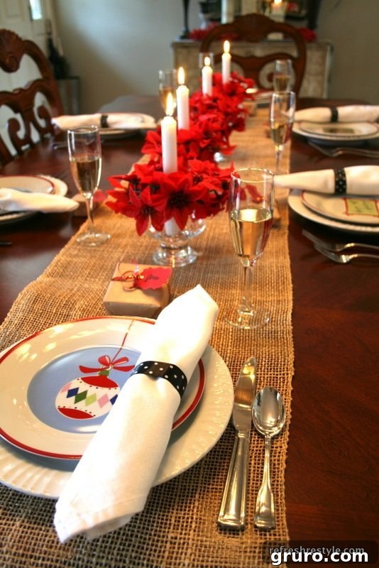 A holiday table setting with artificial poinsettias arranged in small dessert cups.