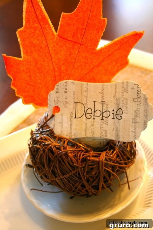 A rustic table setting featuring a small bird's nest and a paper leaf accent.
