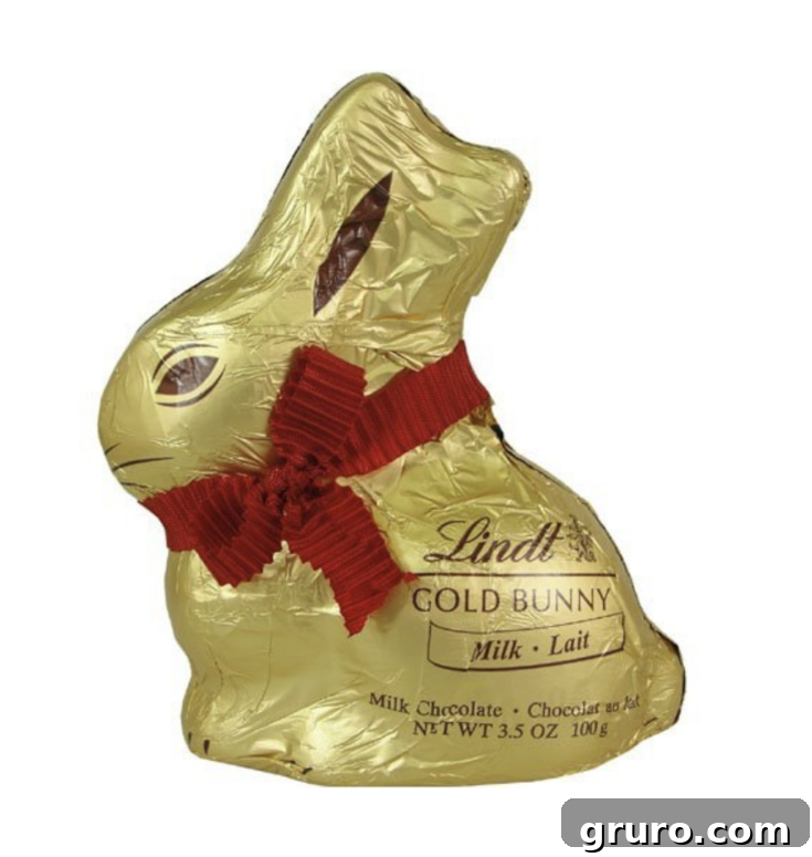 A classic Lindt Gold Easter Bunny, wrapped in gold foil with a red ribbon and bell.