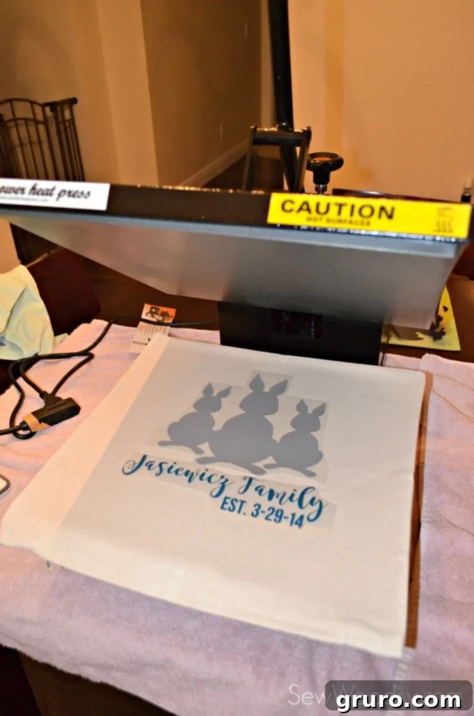 Aligning iron-on bunny and family name on the canvas pillow cover