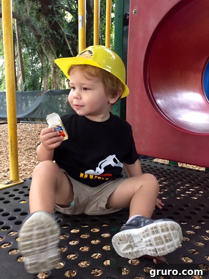 Ryder on the playground wearing his 2nd Birthday Construction T-Shirt and hard hat